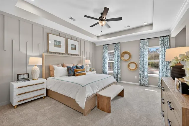 a bedroom with a bed flat screen tv and couches