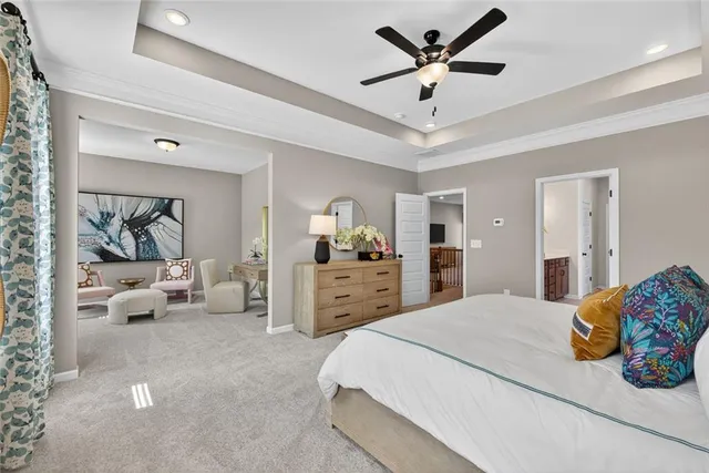 a bedroom with a bed and ceiling fan
