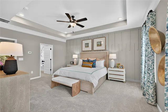 a spacious bedroom with a bed and a chandelier