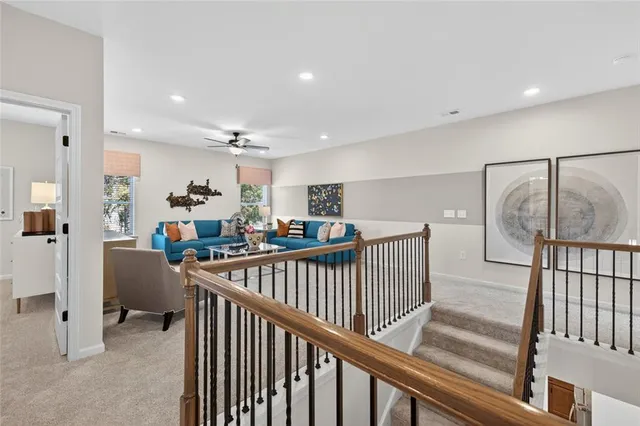 a view of a hallway with workspace and livingroom with furniture