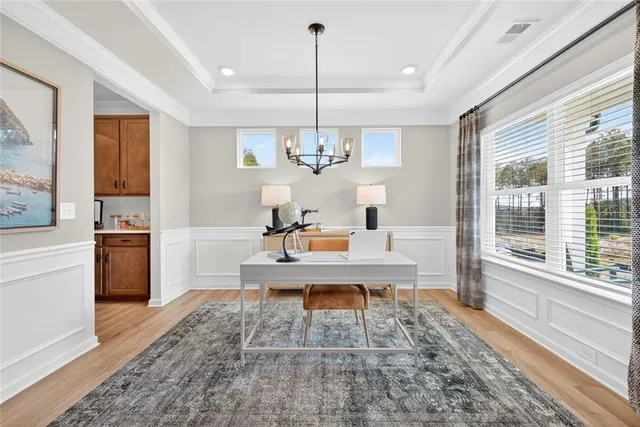 a living room with kitchen island furniture and a chandelier