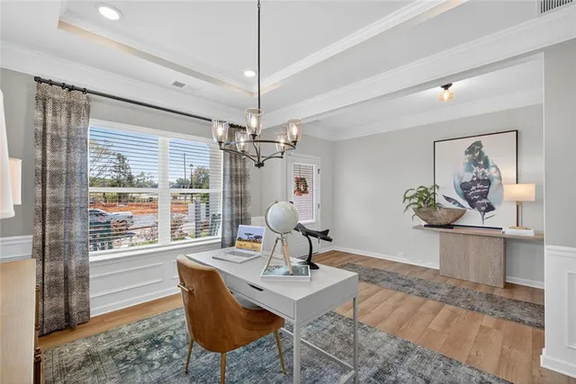 a living room with couch a dining table and a chandelier