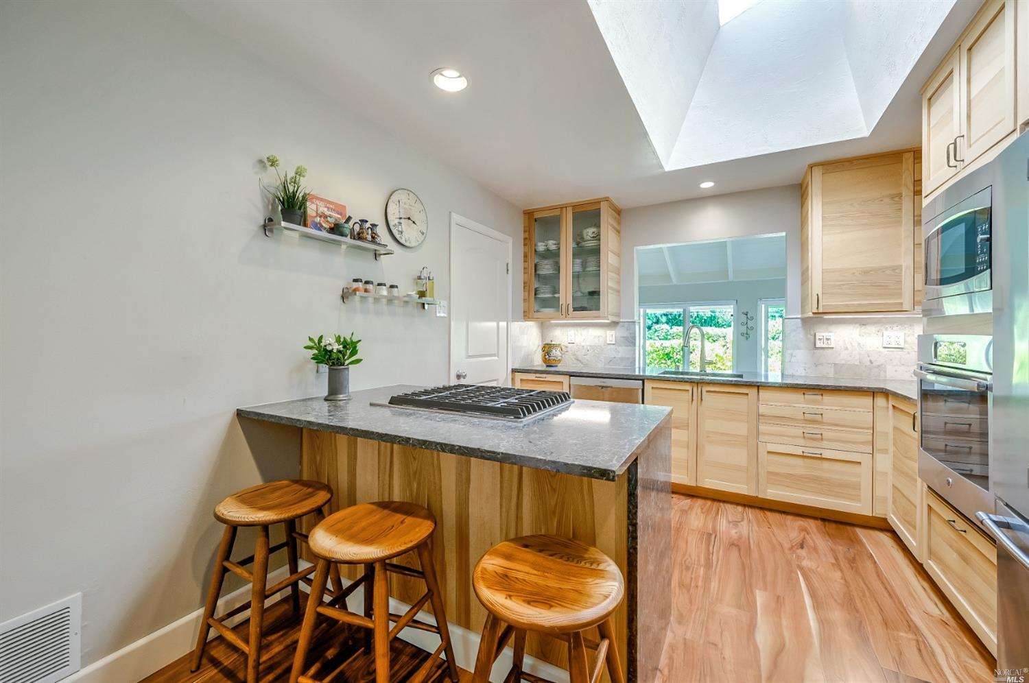 4 Racquet Club Drive San Rafael, CA 94901 - Photo 1 of 1 REMODELED KITCHEN WITH QUARTZ COUNTER TOPS, MARBLE BACKSPLASH, ASH CABINETS, STAINLESS APPLIANCES INCLUDING GAS COOKTOP.
