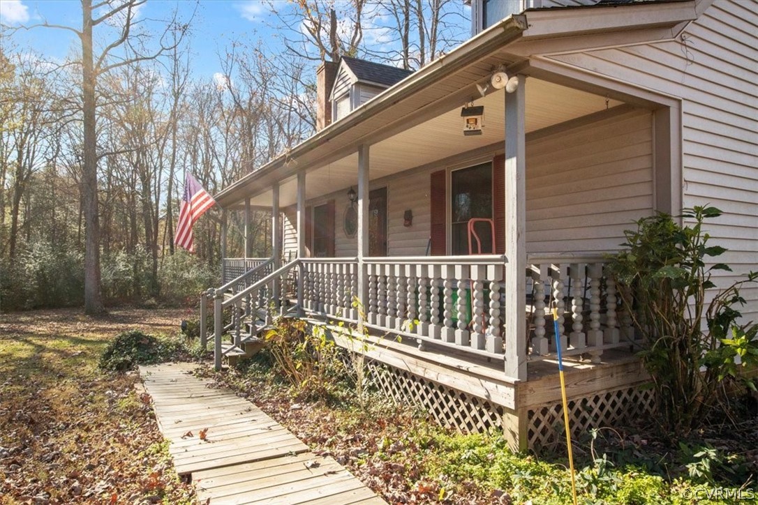 11124 Alanthus Road Midlothian, VA 23112 - Photo 24 of 28 a view of a house with a small yard and wooden fence and floor to ceiling window