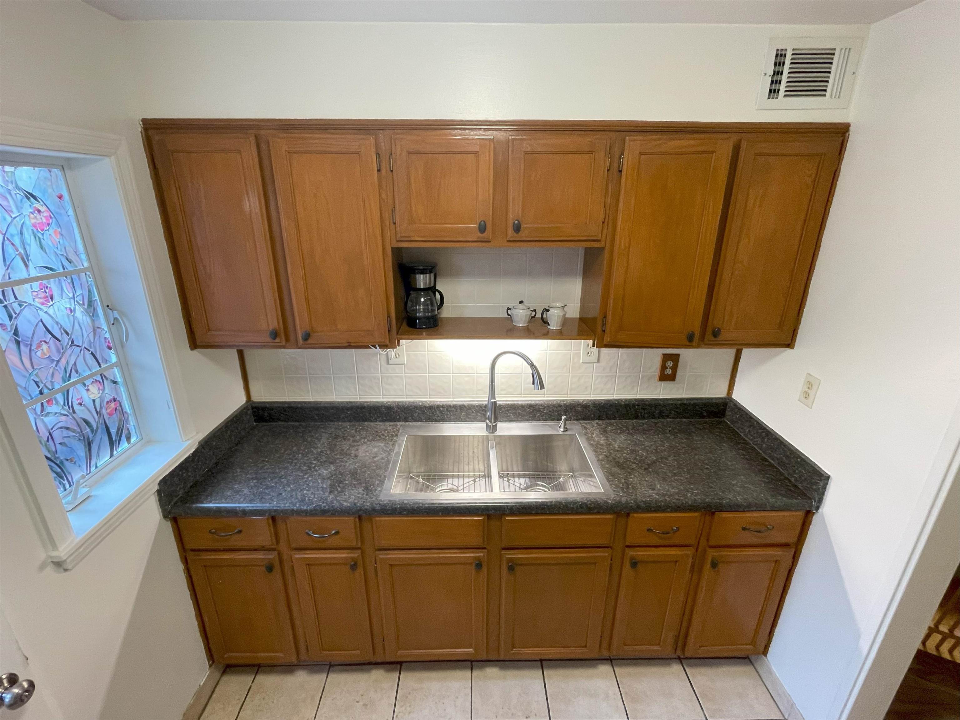 3007 Walnut Grove Road, Unit 1 Memphis, TN 38111 - Photo 2 of 14 a kitchen with granite countertop a sink and a stove