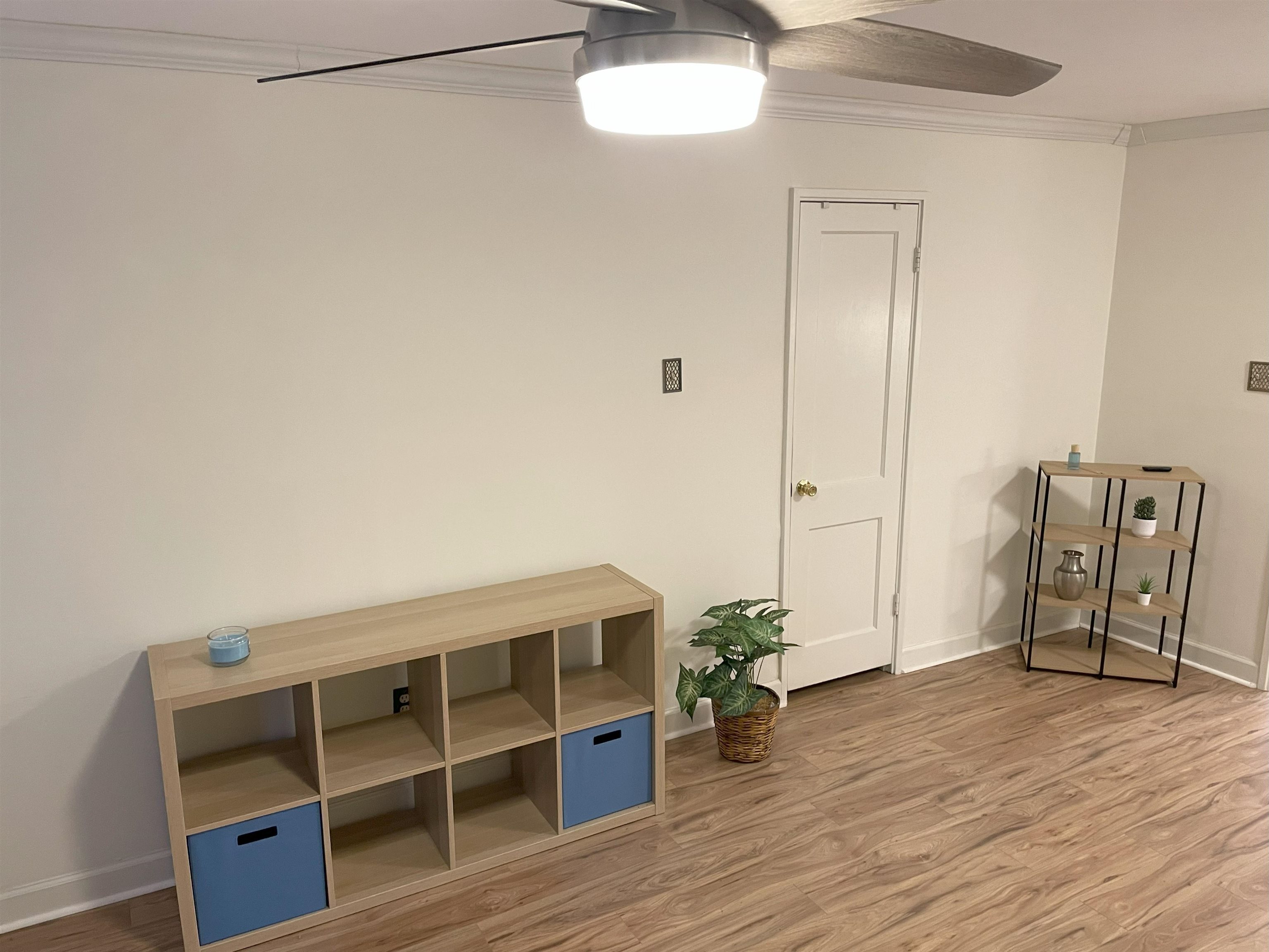 3007 Walnut Grove Road, Unit 1 Memphis, TN 38111 - Photo 4 of 14 a view of an empty room with wooden floor and small cabinets