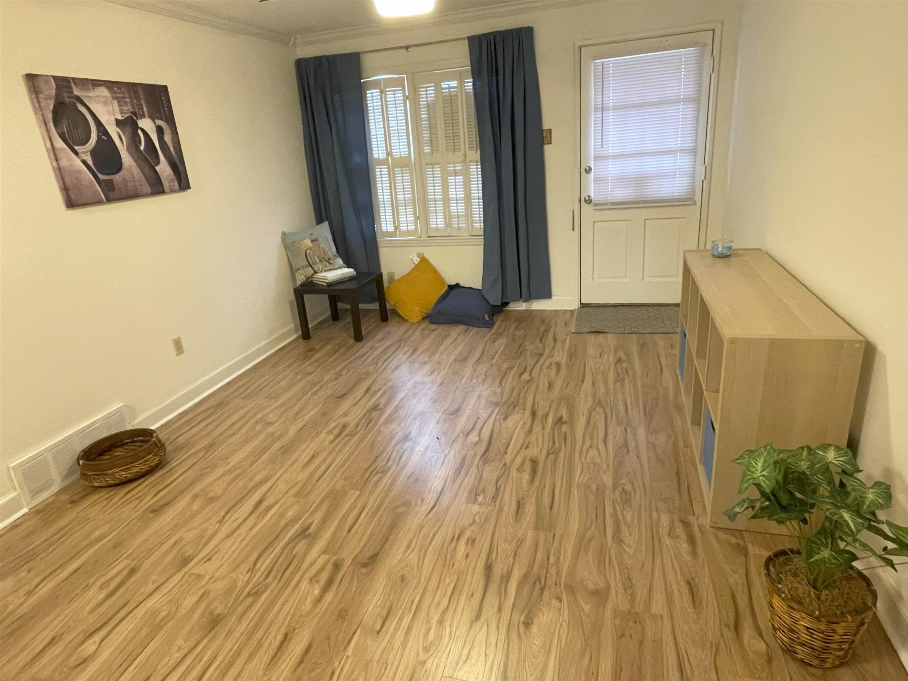 3007 Walnut Grove Road, Unit 1 Memphis, TN 38111 - Photo 5 of 14 a bedroom with a bed and wooden floor