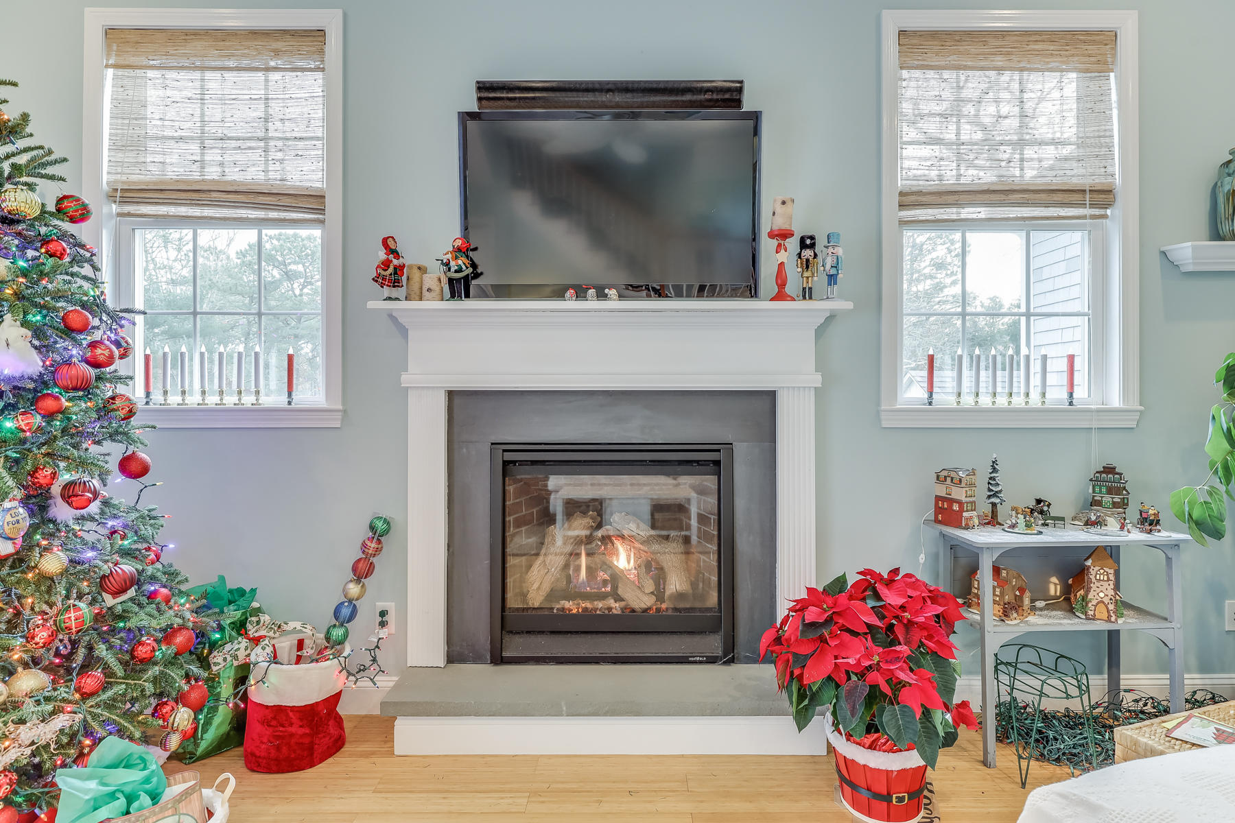 39 Nobska Road Mashpee, MA 02649 - Photo 10 of 33 a living room with painting on the wall and a fireplace