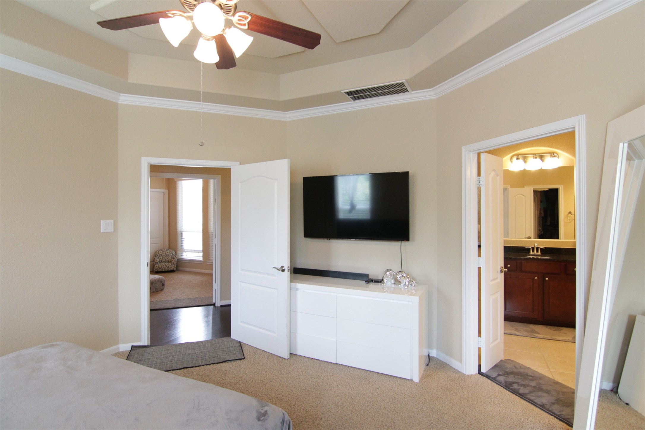 1423 Ralston Branch Way Sugar Land, TX 77479 - Photo 22 of 43 primary bedroom with ceiling fan & French doors to primary bath