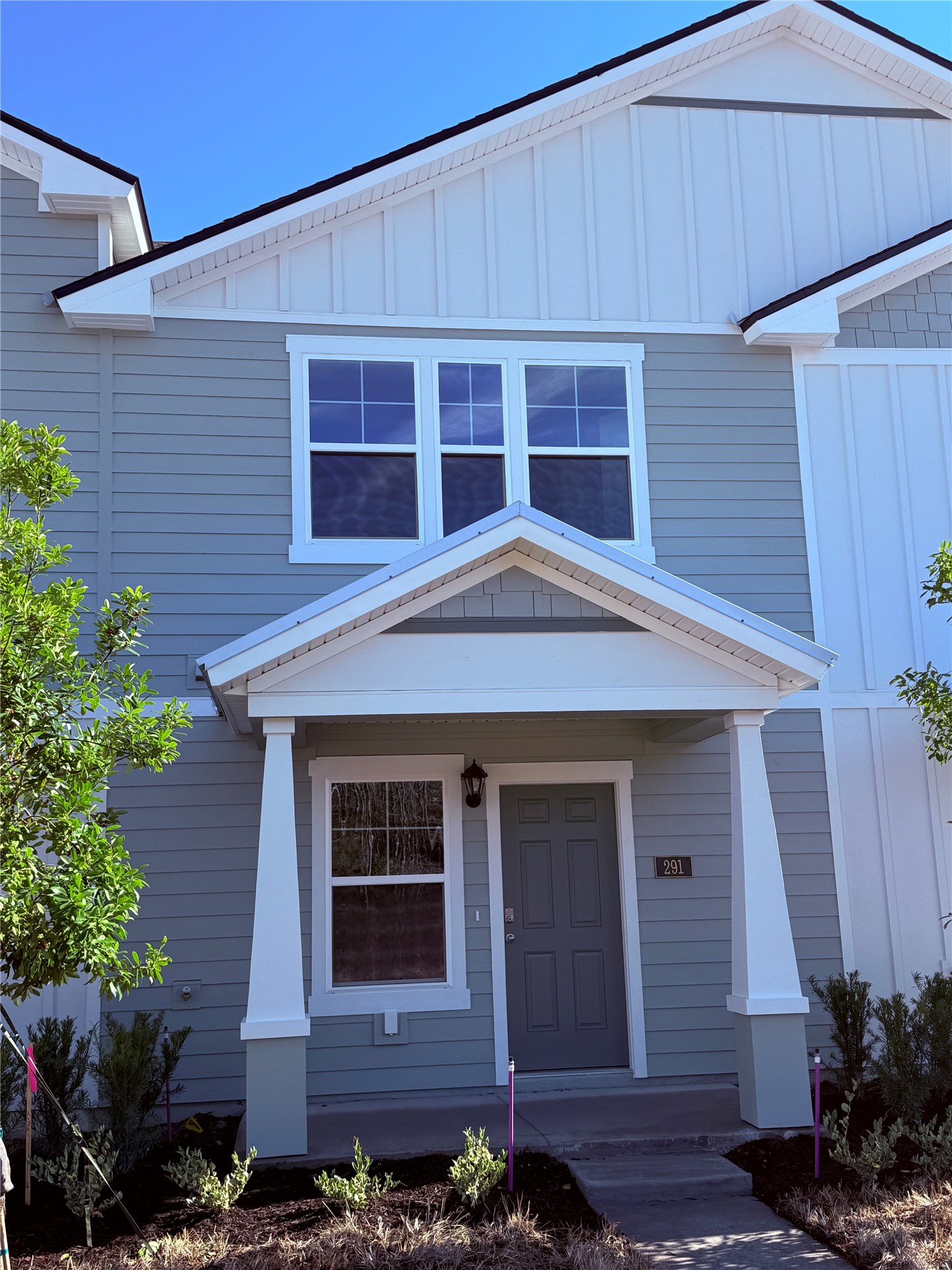 a front view of a house with a garden