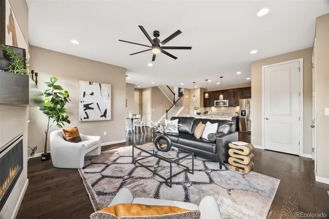 a living room with patio furniture and a potted plant
