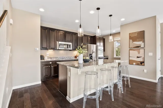 a large kitchen with a table and chairs