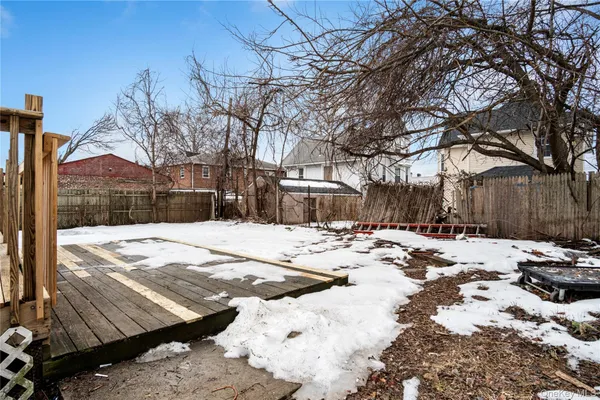 a view of a yard with snow on the road