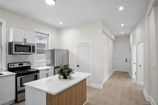 a kitchen with stainless steel appliances a refrigerator sink stove microwave and cabinets