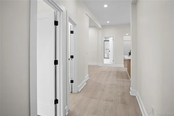 a view of a hallway with wooden shelves