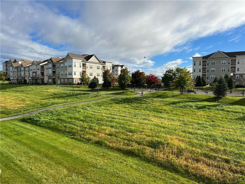 2356 Raya Way Easton, PA 18045 - Photo 26 of 28 Meticulously maintained green spaces connect the residential buildings under a bright sky.