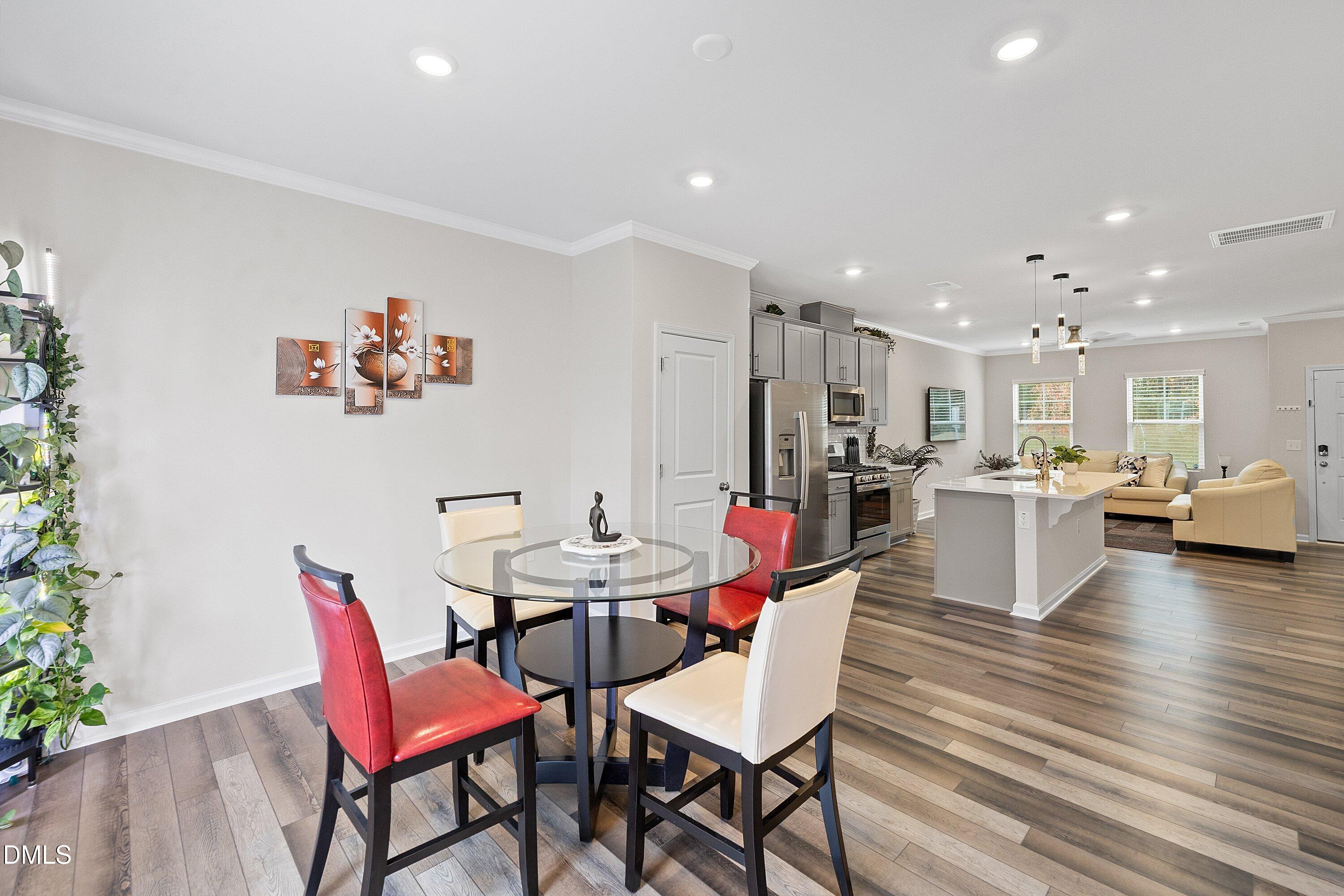 4949 Microcline Trail Raleigh, NC 27610 - Photo 9 of 42 a view of a dining room with furniture and wooden floor