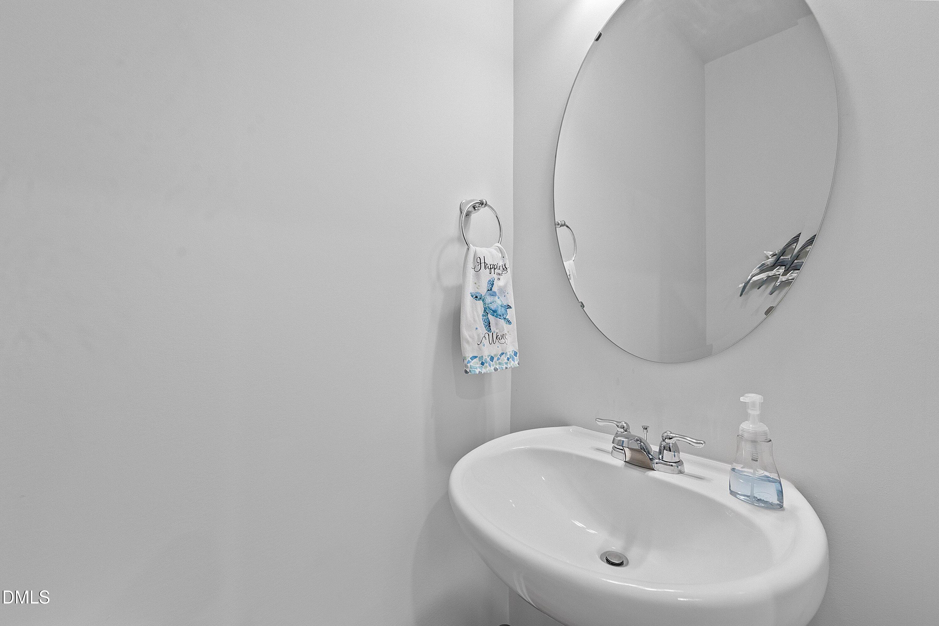 4949 Microcline Trail Raleigh, NC 27610 - Photo 10 of 42 a bathroom with a sink and a mirror