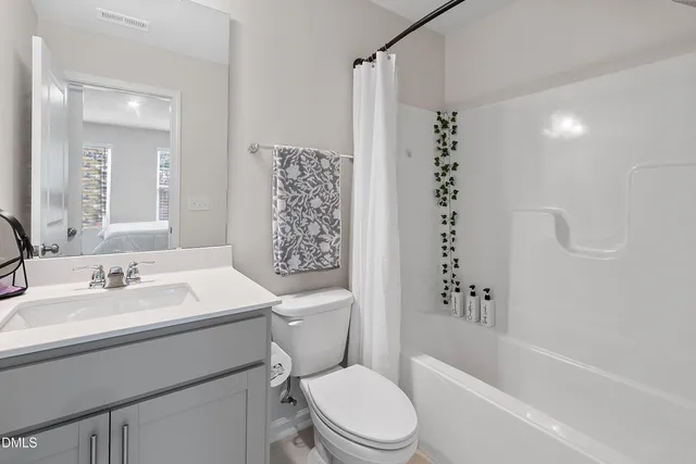 a en suite bathroom with double sink and a mirror
