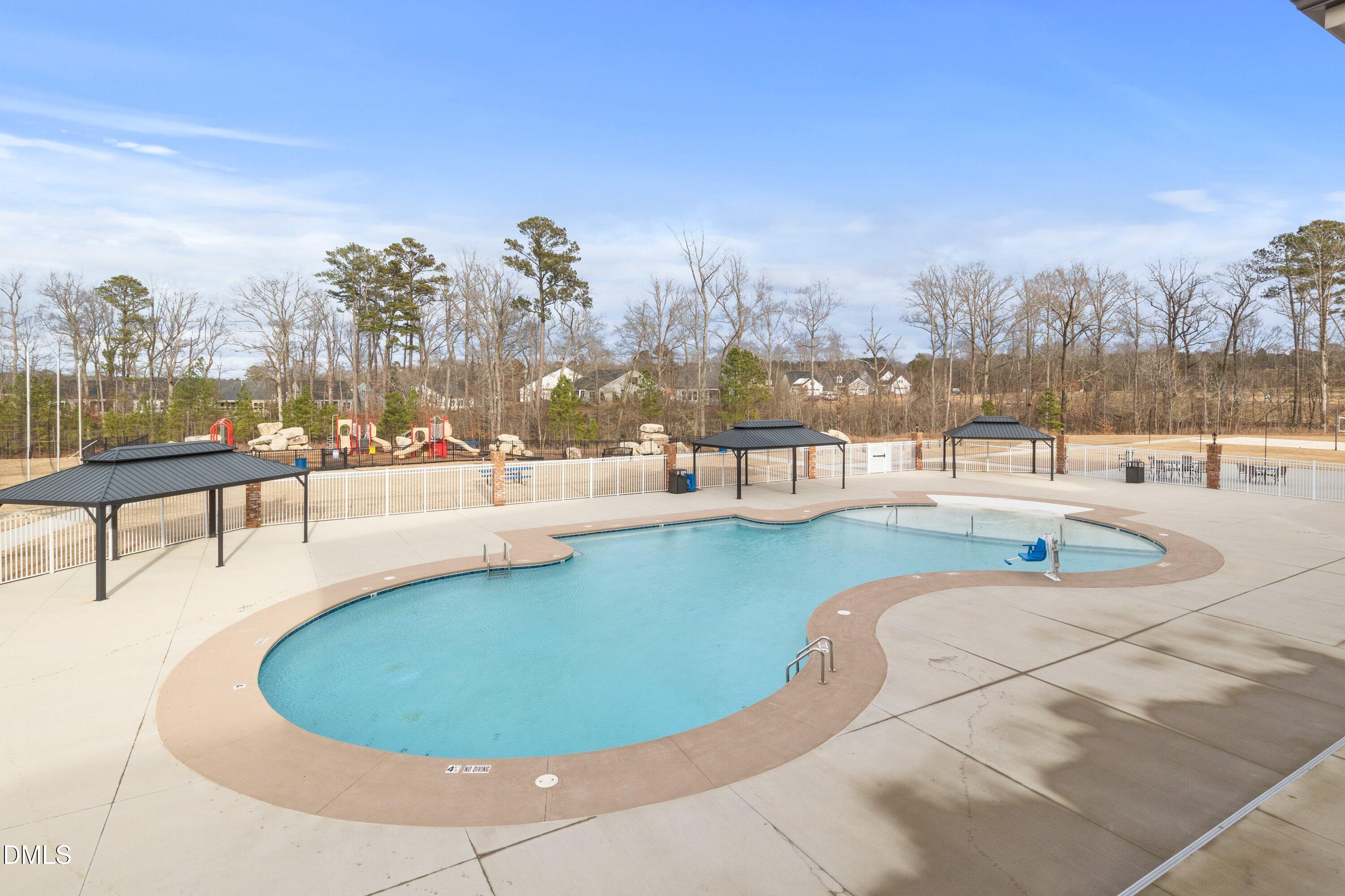 4949 Microcline Trail Raleigh, NC 27610 - Photo 19 of 42 a view of a swimming pool with outdoor seating and city view