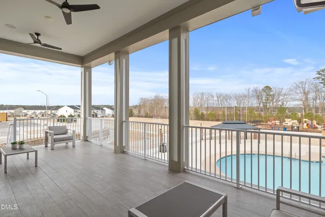 an aerial view of a house with swimming pool patio and outdoor seating