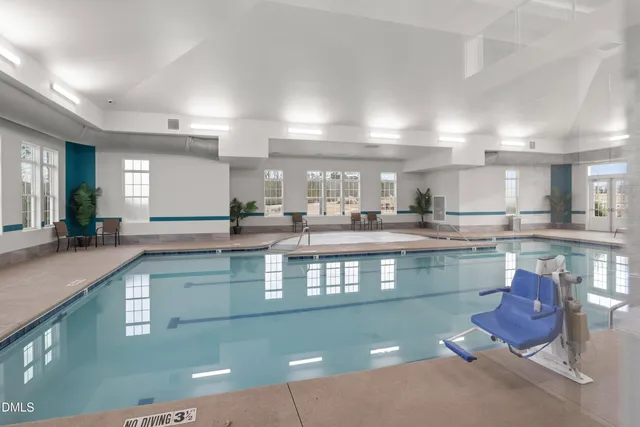 a dining room with stainless steel appliances kitchen island granite countertop a table chairs and a dining table with wooden floor