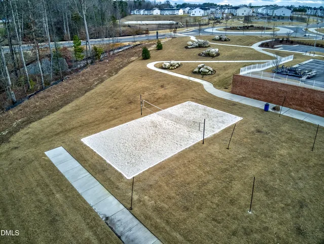 a room with lots of white furniture and chandelier