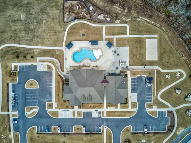 a view of a swimming pool with a yard from a sink