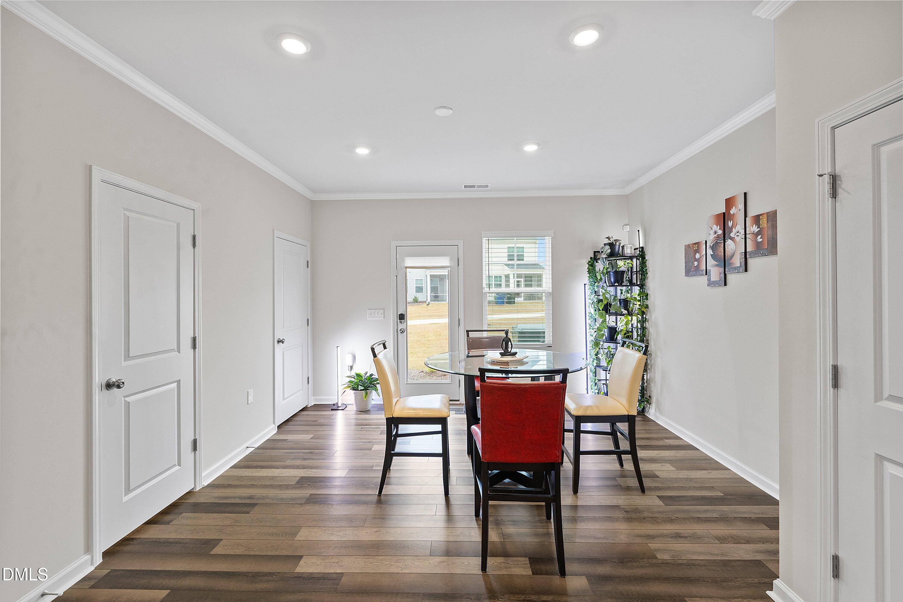 4949 Microcline Trail Raleigh, NC 27610 - Photo 4 of 42 a view of a dining room with furniture window and wooden floor