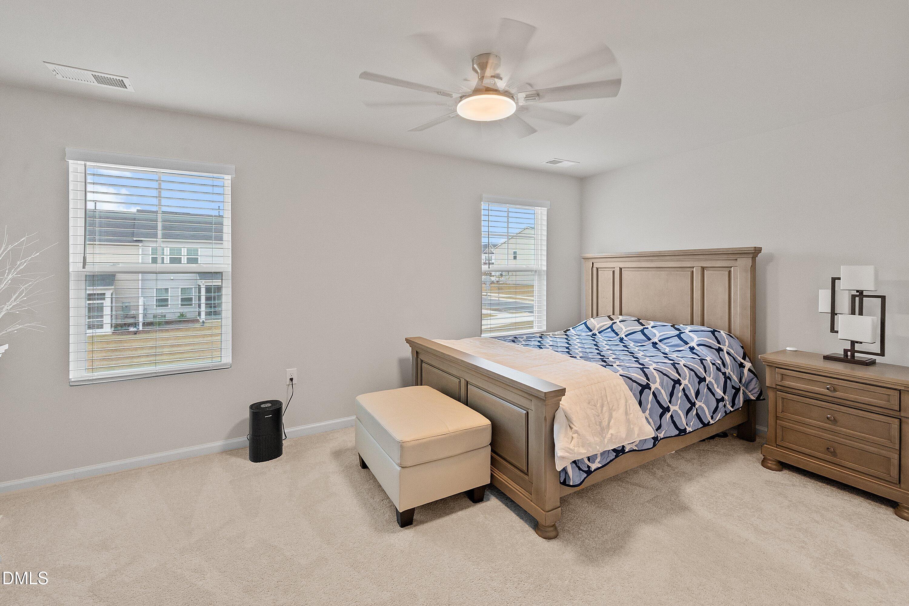 4949 Microcline Trail Raleigh, NC 27610 - Photo 5 of 42 a bedroom with a bed and a chandelier