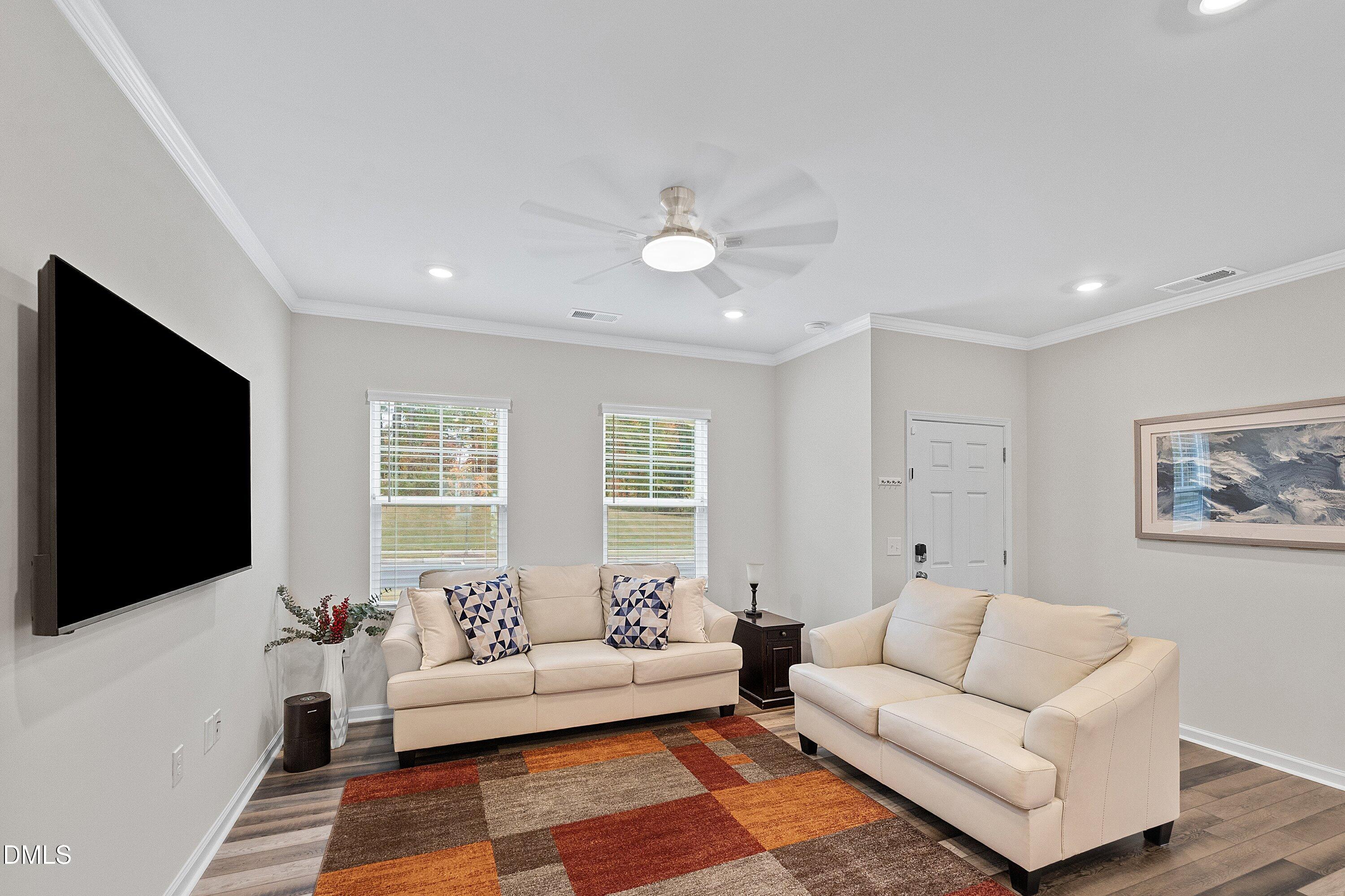 4949 Microcline Trail Raleigh, NC 27610 - Photo 6 of 42 a living room with furniture and a flat screen tv