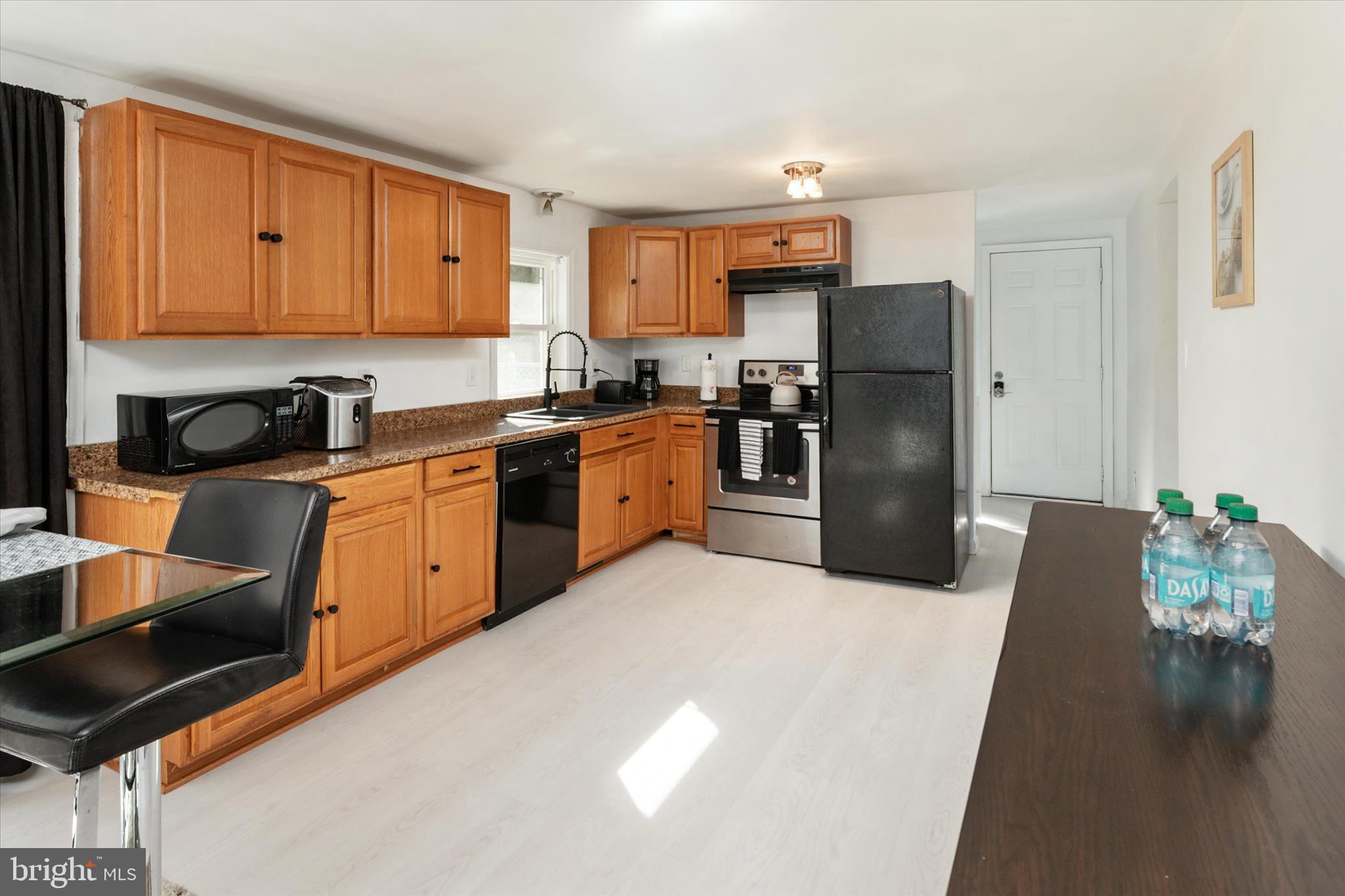 108 Wilson Road Grasonville, MD 21658 - Photo 8 of 38 a kitchen with granite countertop a refrigerator stove top oven and sink