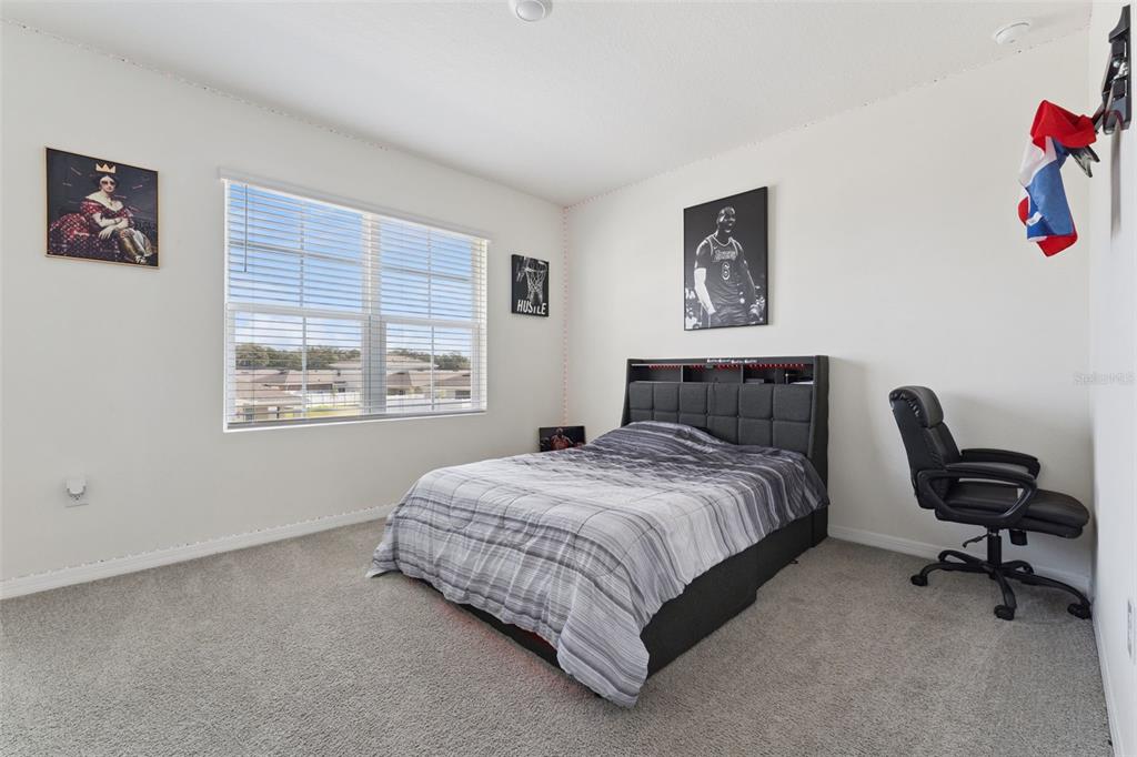 1502 Bitteroot Street Kissimmee, FL 34744 - Photo 14 of 29 a bedroom with a bed and a window