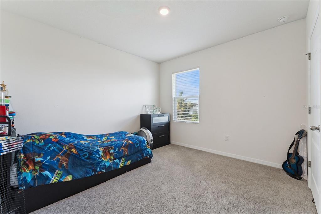 1502 Bitteroot Street Kissimmee, FL 34744 - Photo 15 of 29 a bedroom with a bed and a window