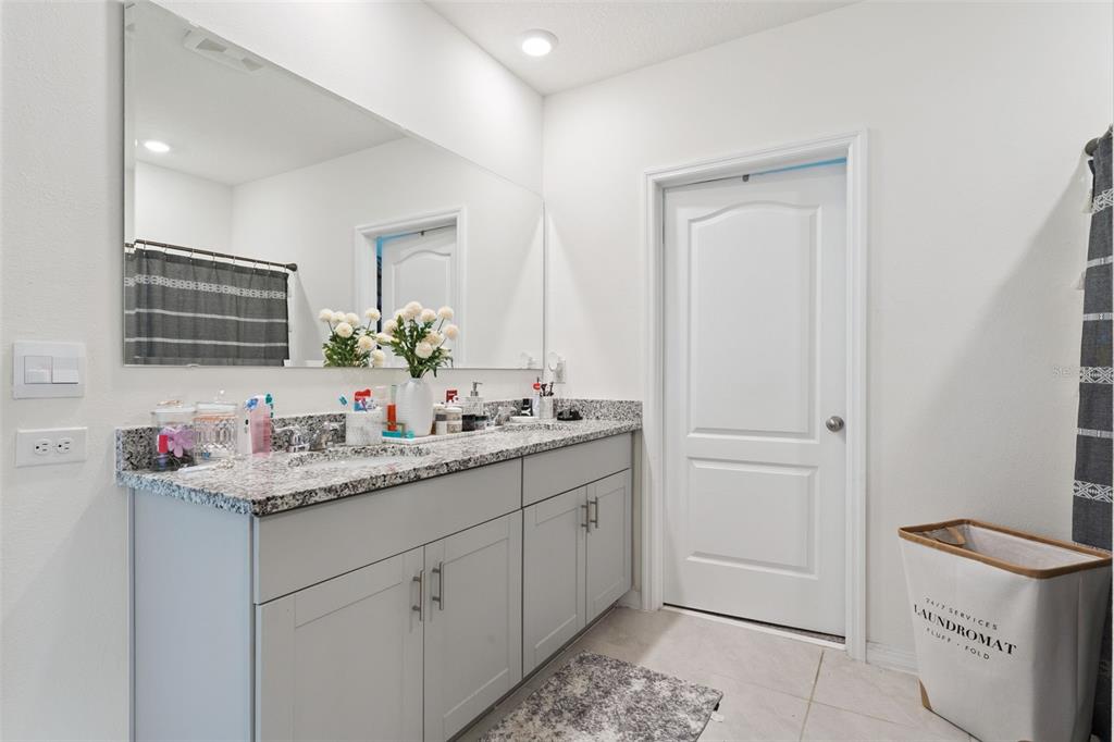 1502 Bitteroot Street Kissimmee, FL 34744 - Photo 16 of 29 a bathroom with a sink and a mirror