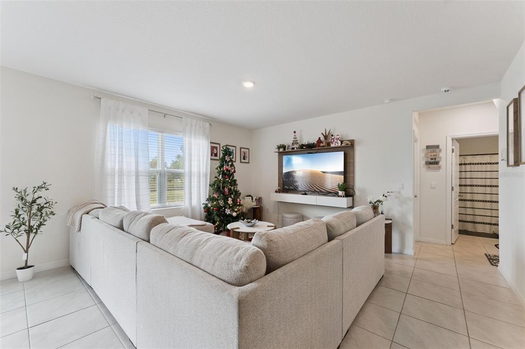 1502 Bitteroot Street Kissimmee, FL 34744 - Photo 4 of 29 a living room with furniture and a flat screen tv