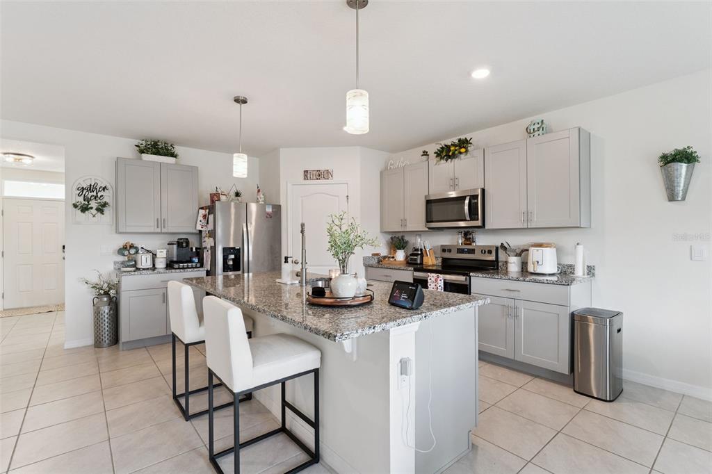 1502 Bitteroot Street Kissimmee, FL 34744 - Photo 8 of 29 a kitchen with refrigerator and chairs