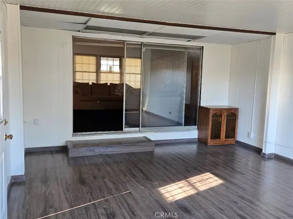 a kitchen with granite countertop wooden cabinets a sink and a window