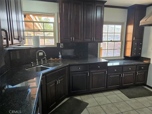 a kitchen with a sink a stove and cabinets