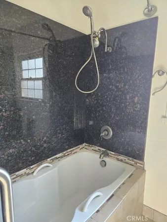 a bathroom with a sink a toilet and a shower