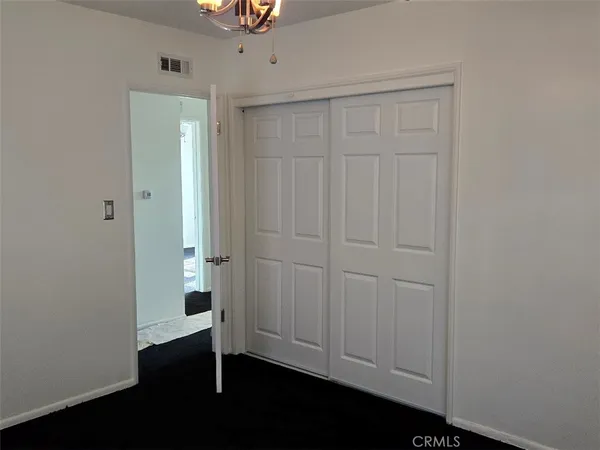 an empty room with closet area