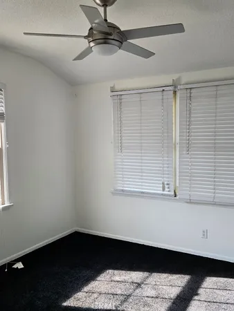 a view of a room with wooden floor and a window