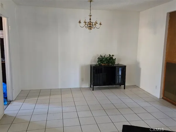 a view of a room with wooden floor and a window