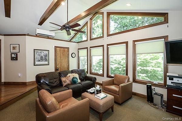 32 Randy Lane Plainview, NY 11803 - Photo 11 of 26 a living room with furniture a ceiling fan and a large window