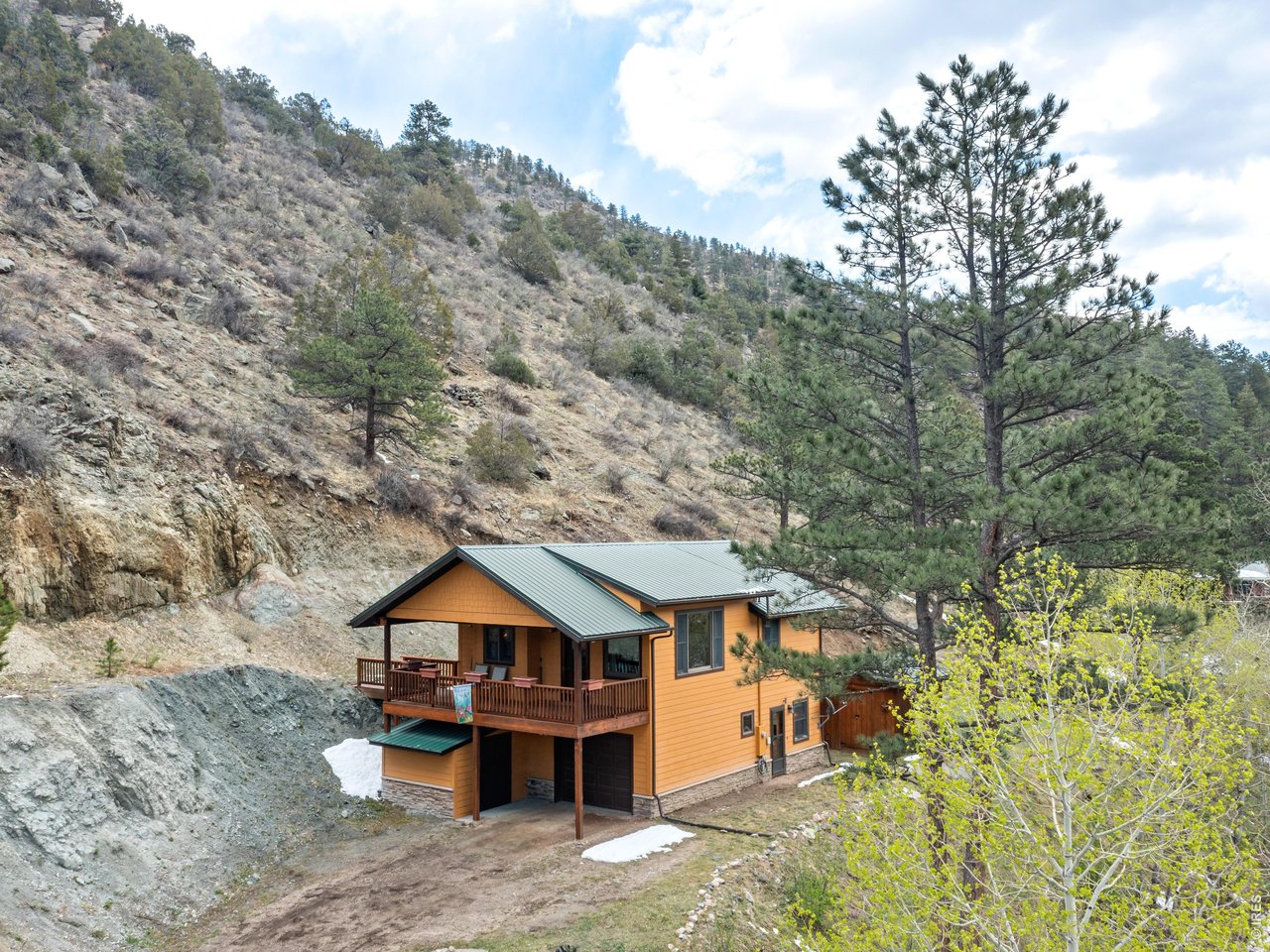 1002 Streamside Drive Drake, CO 80515 - Photo 4 of 37 a front view of a house with a yard basket ball court and outdoor seating