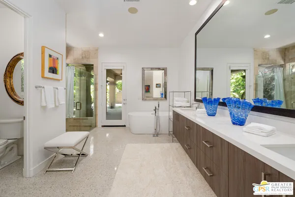 a bathroom with a tub sink and mirror