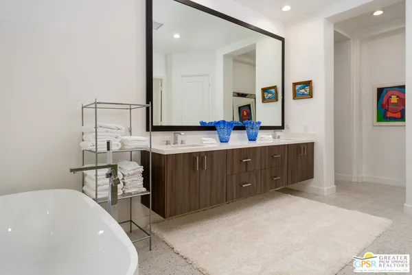 a bathroom with a granite countertop sink mirror vanity and toilet