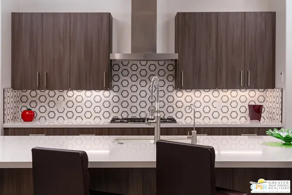 a kitchen with stainless steel appliances granite countertop a stove and a microwave oven