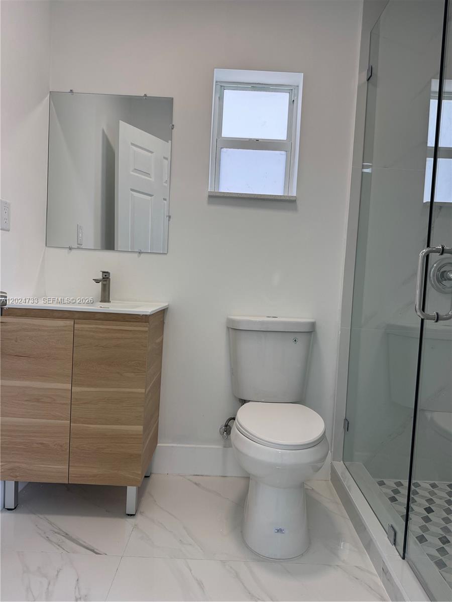 3305 Southwest 28th Street, Unit 3305 Miami, FL 33133 - Photo 10 of 17 a bathroom with a toilet and a sink