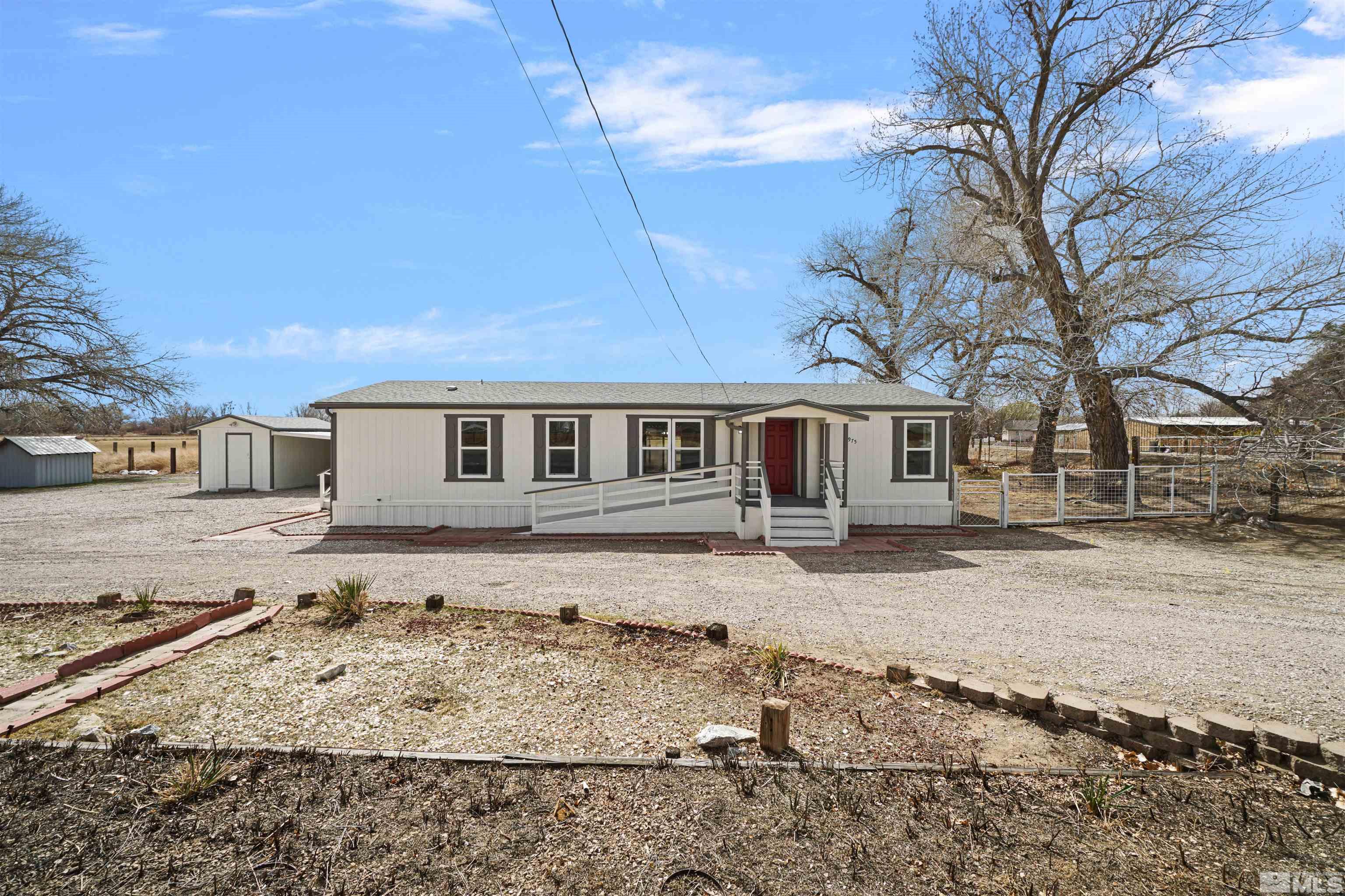 3975 Alcorn Road Fallon, NV 89406 - Photo 1 of 21 a front view of a house with a yard